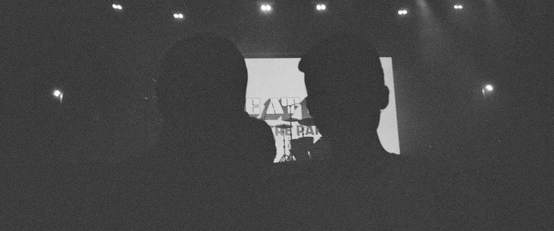 Black silhouettes of the developer and a friend